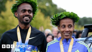 Ethiopians Milkesa Mengesha, who won the men's race, and Tigist Ketema, victor in the women's race, with their medals at the Berlin Marathon