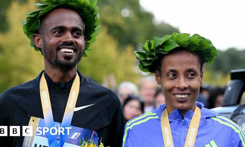 Ethiopians Milkesa Mengesha, who won the men's race, and Tigist Ketema, victor in the women's race, with their medals at the Berlin Marathon