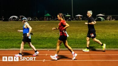 Competitors run through the night in the Sri Chinmoy 24hr Track Race in Battersea Park